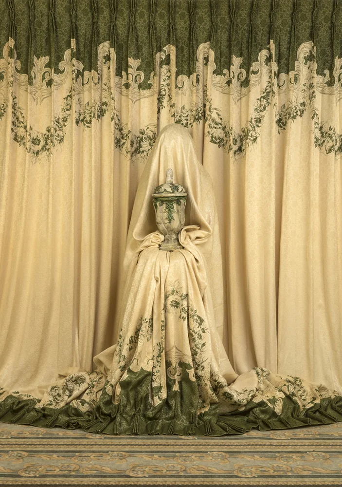 Curtains concealing model holding urn