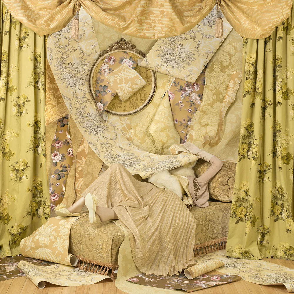 busy patterned staging yellow draped fabrics woman bed