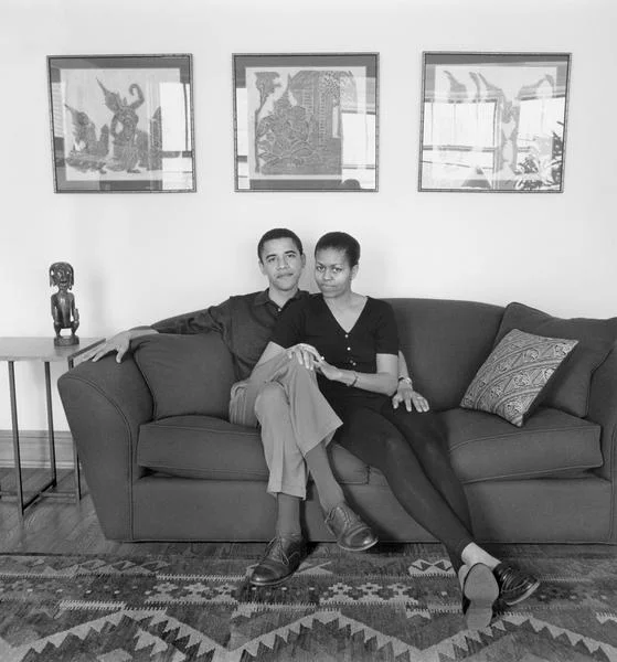 Barack and Michelle Obama sitting on couch