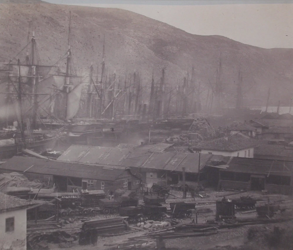 looking over clustered buildings and smoke