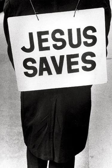 man wearing Jesus Saves placard