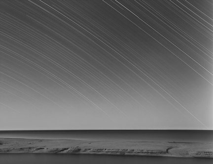time lapse nightsky - seascape with motion blur stars