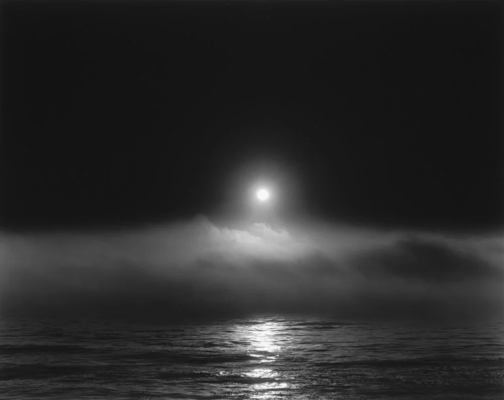 fog moon rising over sea