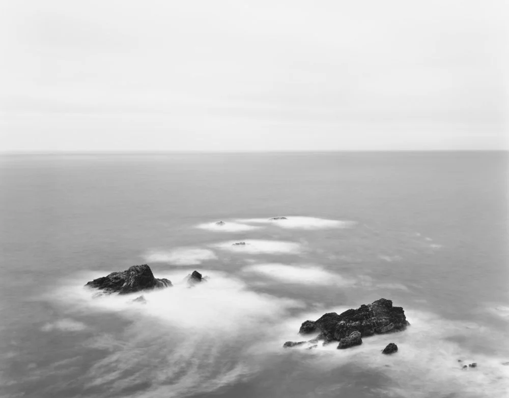 distant rock crops in ocean