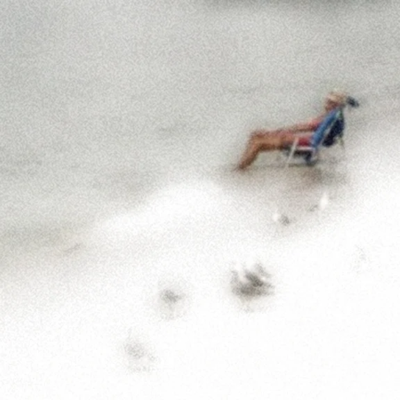 man in chair in waves beach