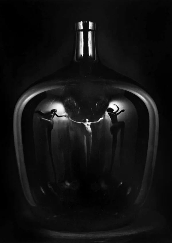 women reflected in glass bottle
