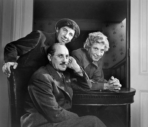 The Marx Brothers posing over table