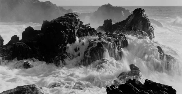 waves crash rock