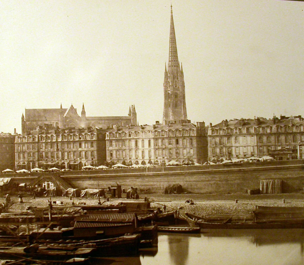 view of french city and steeple from water
