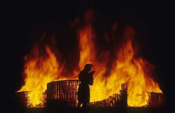 man parying large fire