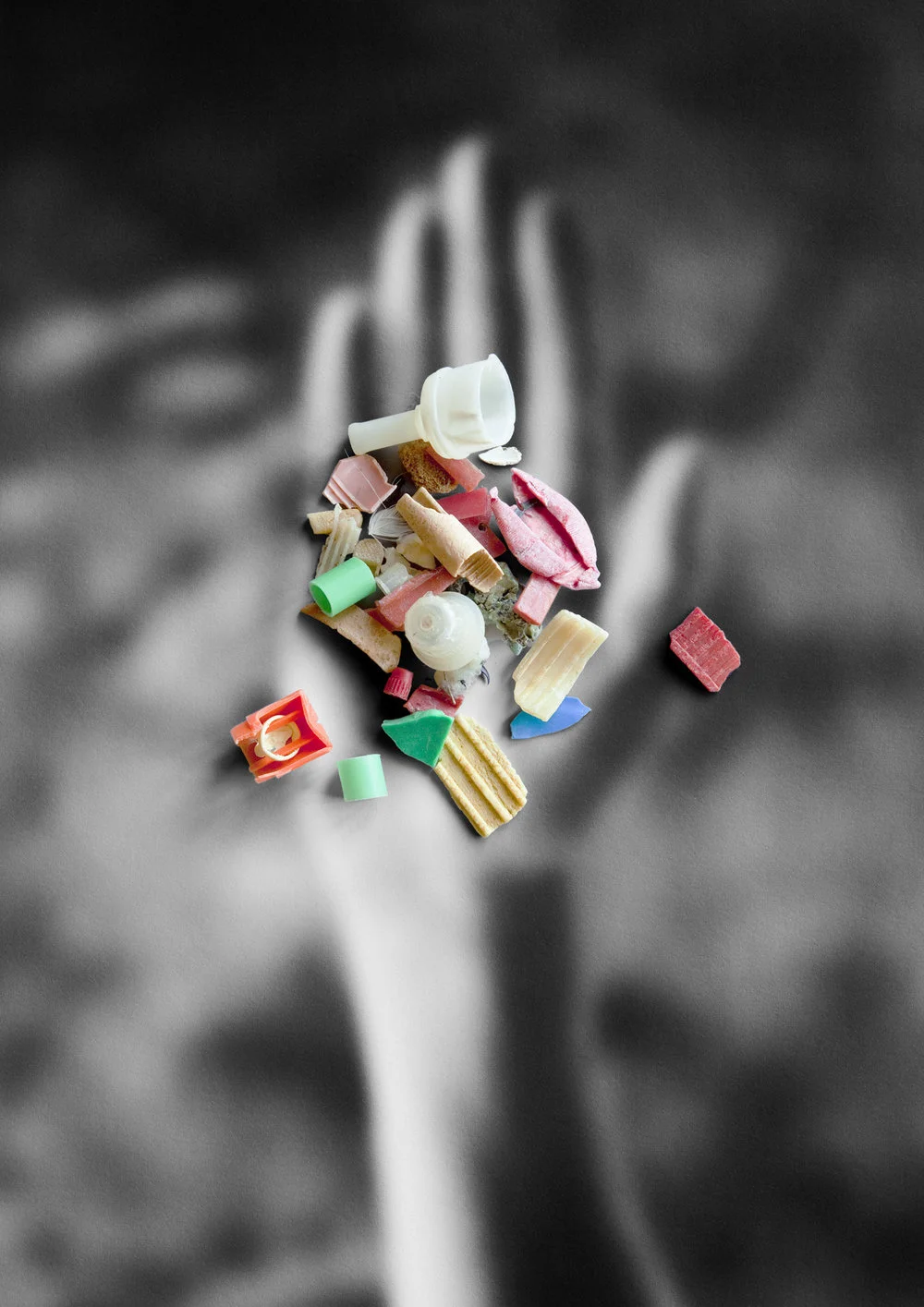 plastic litter on photo of hand