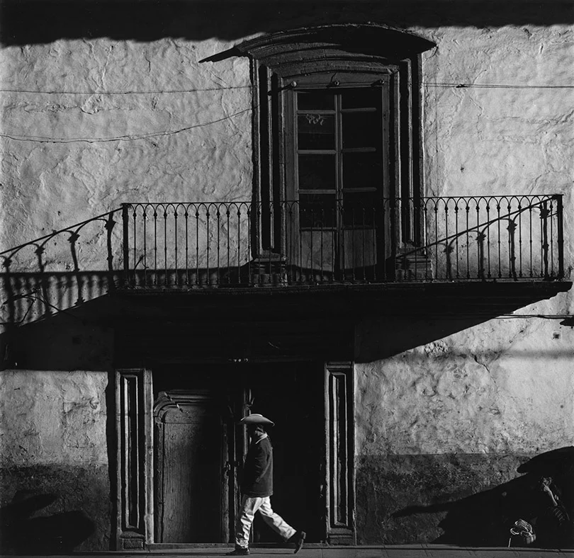 stark contrast balcony man walking under