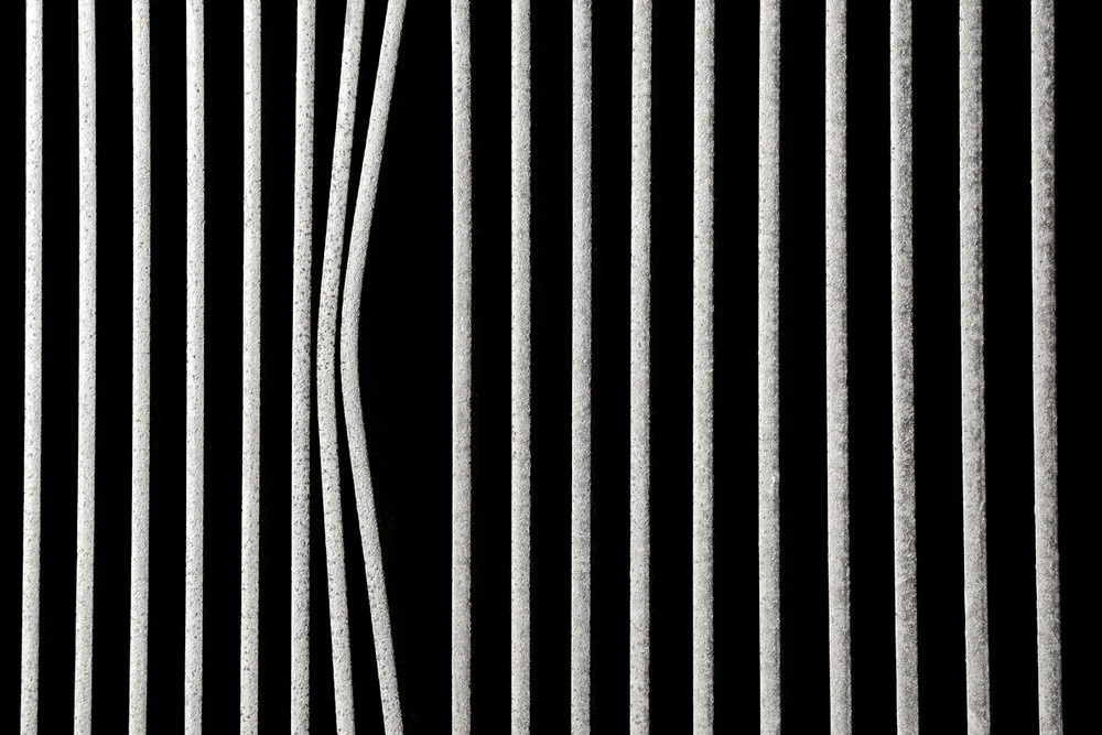 abstract row of bars with bent bar