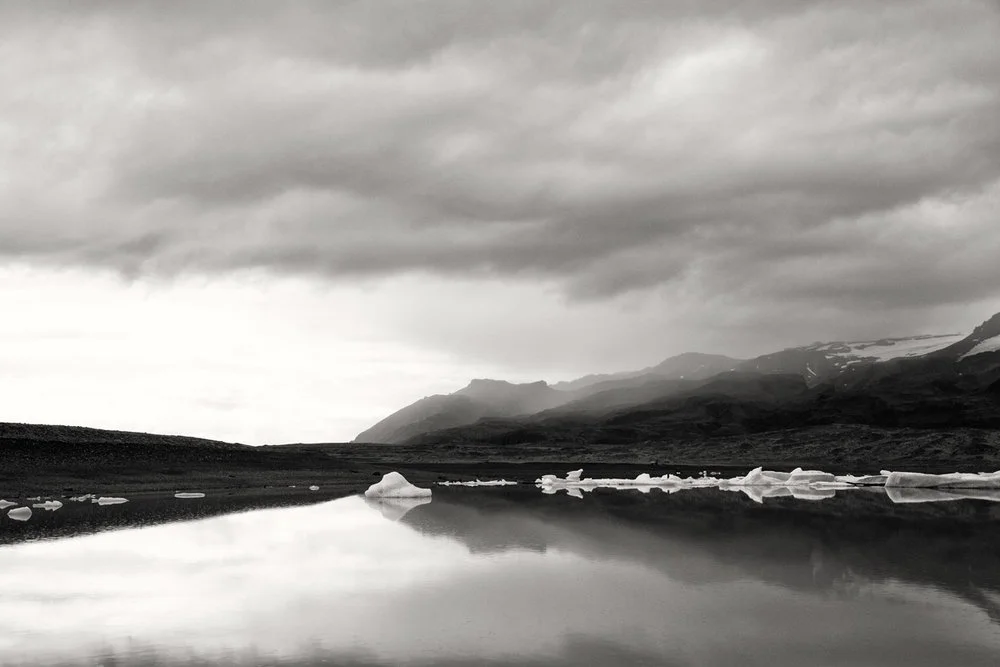 glaciers at distance with sky and water reflections