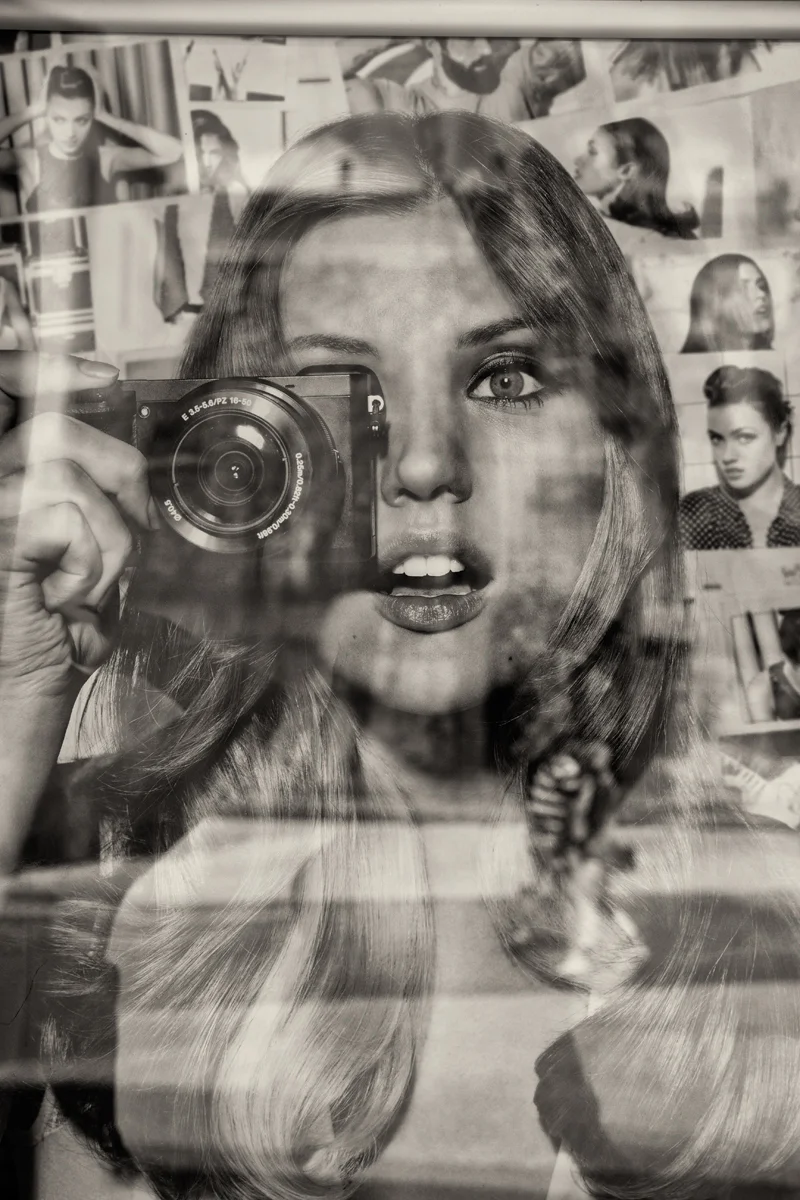 reflective image woman taking photo