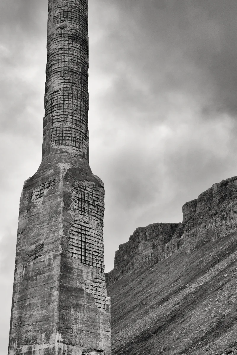 weathered post against rugged landscape