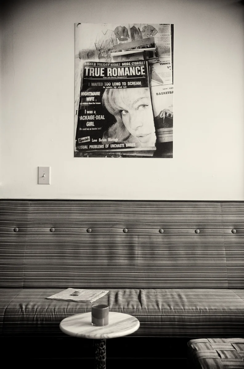cafe cushioned bench true romance poster on wall