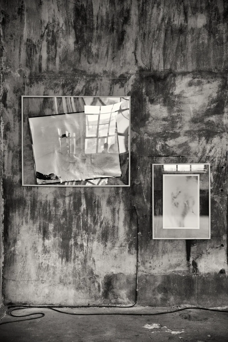 reflective glass encased art hanging on wall