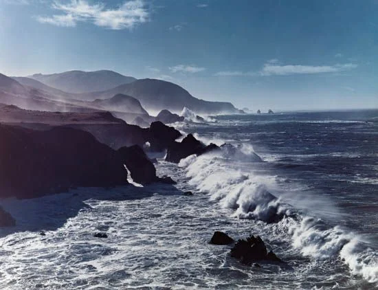 ocean mist waves crash rocky cliff coastline big sur foam clear sky