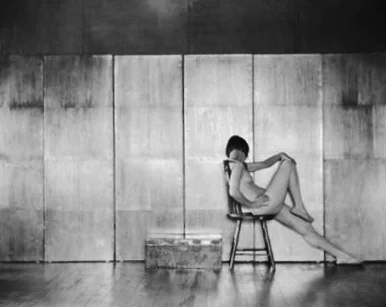 nude posing in chair