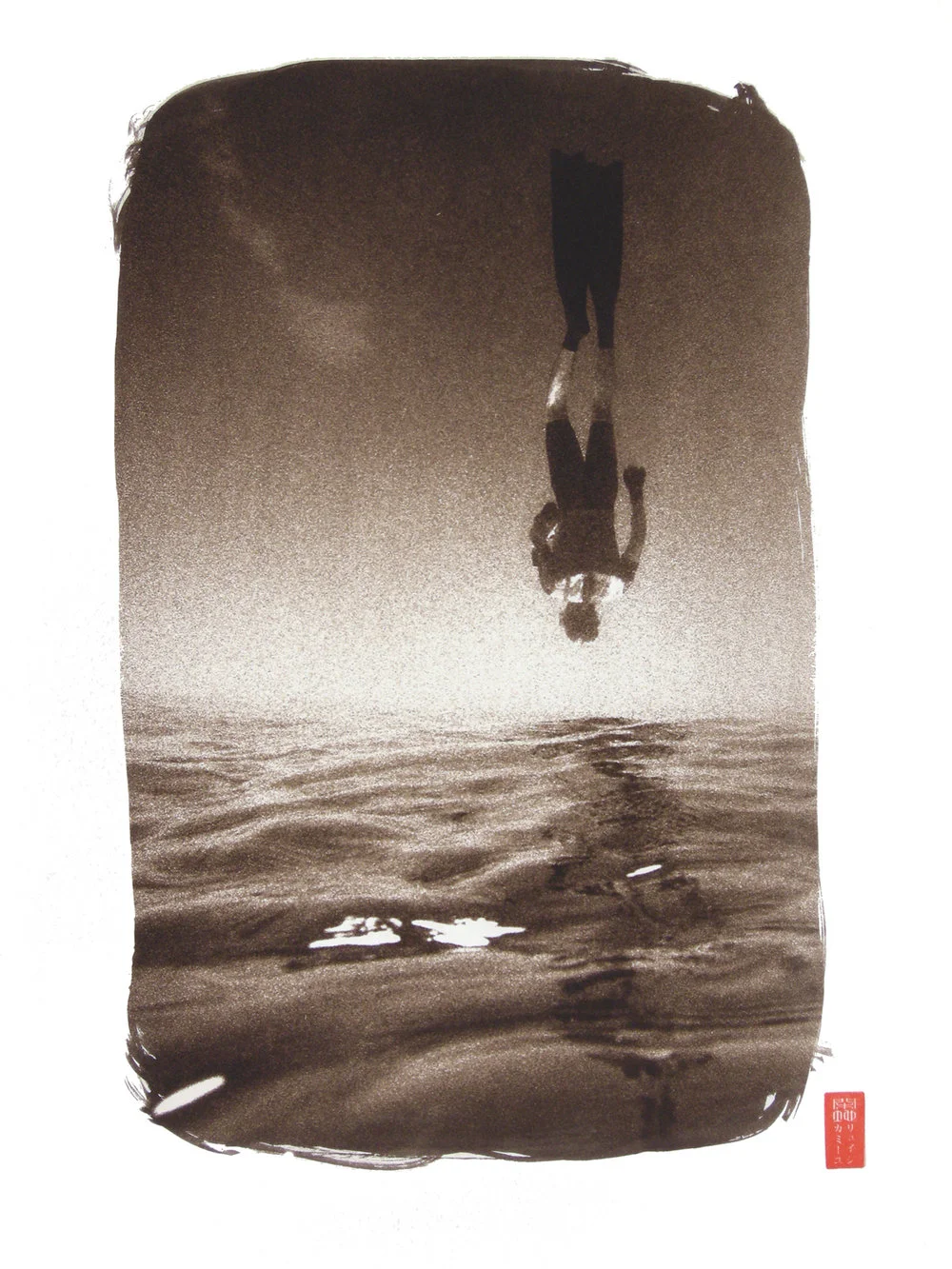 diver in flippers upside down mid dive water beneath