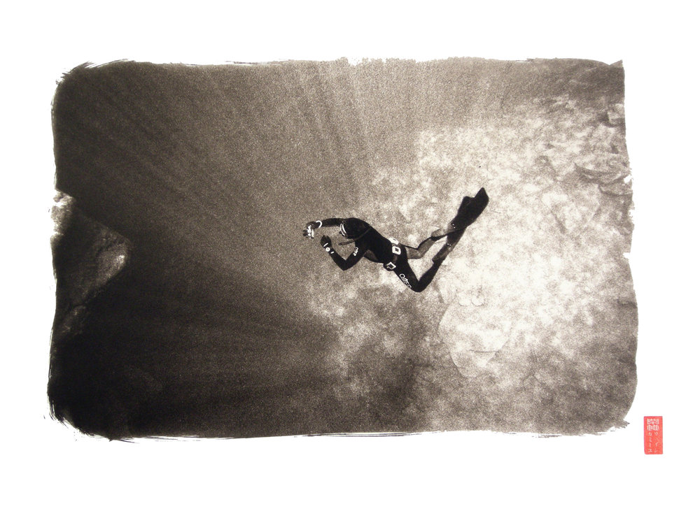 diver in water seen from above against light beams