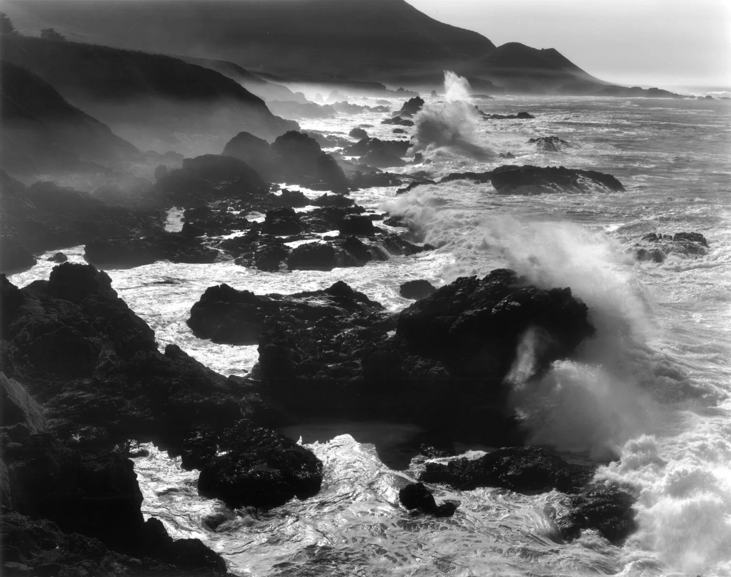 two crashing waves cliffs big sur
