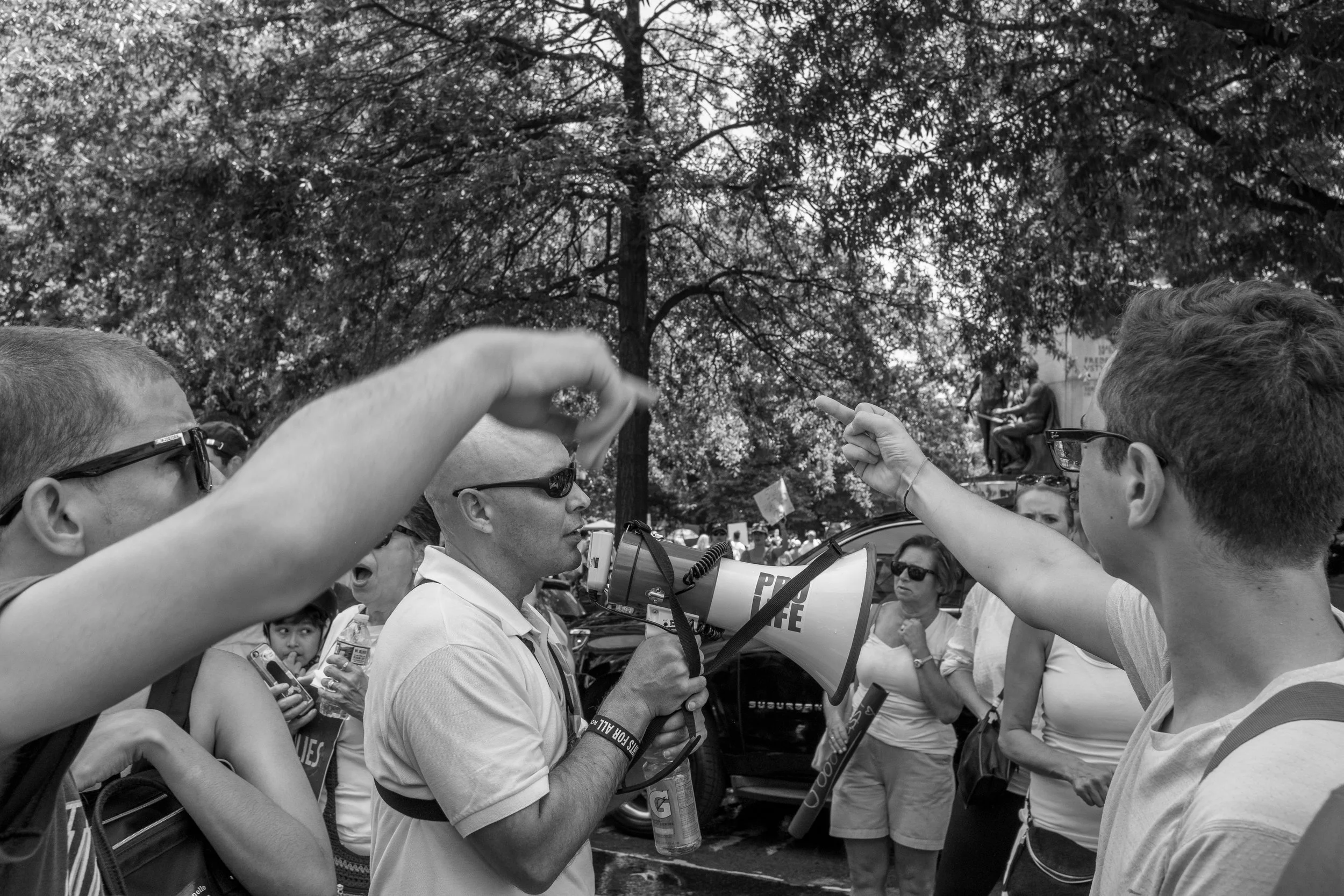 A lone anti-abortion demonstrator provides the only moments of tension in an otherwise peaceful demonstration protesting the Trump Administration’s policy of family separation and child detainment. Washington DC; June 30, 2018.