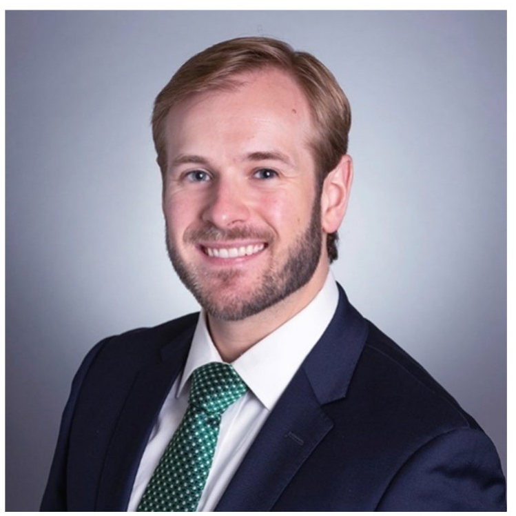 Chris Chenard in a blue suit with green tie.