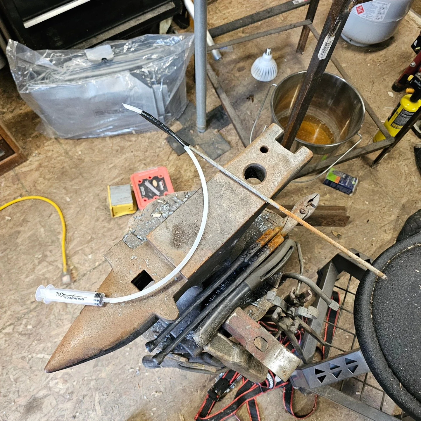 Sometimes, you have to invent a tool. Lawn tractor was running like crap and backfiring. I checked in the gas tank and could see a dead spider clogging up where the hose came out the bottom. So a syringe and some little tubing, and a metal rod to gui