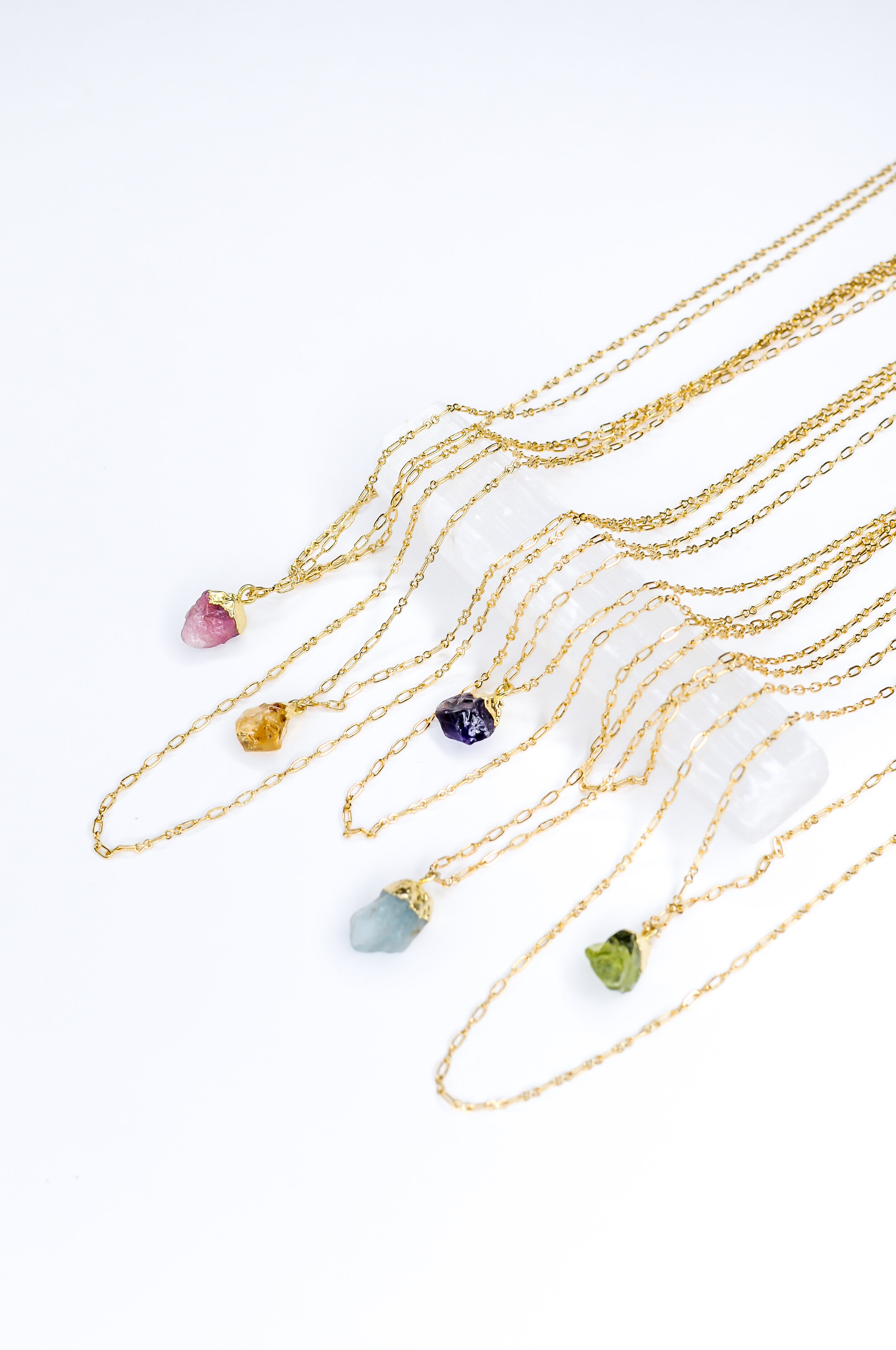  Earth Stoned, Raw Gemstone Necklace, Long Outer Layer  38.00  Small but mighty.  Which stone speaks to you?  Which stone will support someone you love?  This necklace comes in 2 versions: Longer outer layer, where the natural gemstone dangles above 