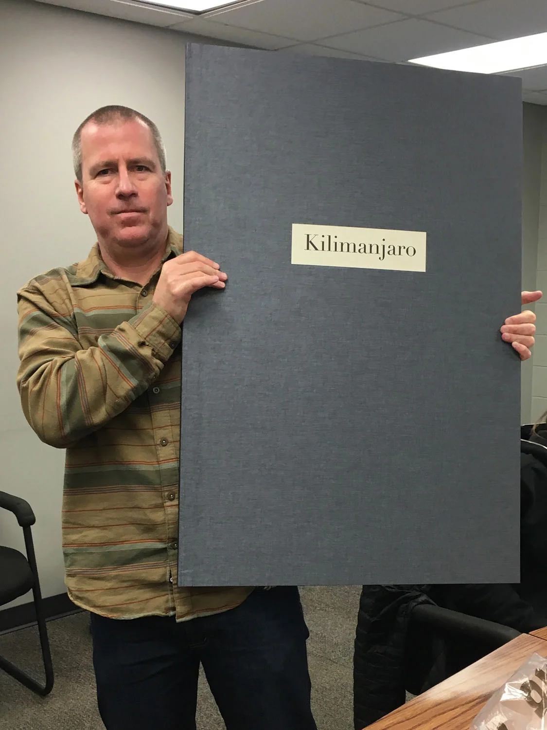 Ian holding Kilimanjaro artist book proof copy