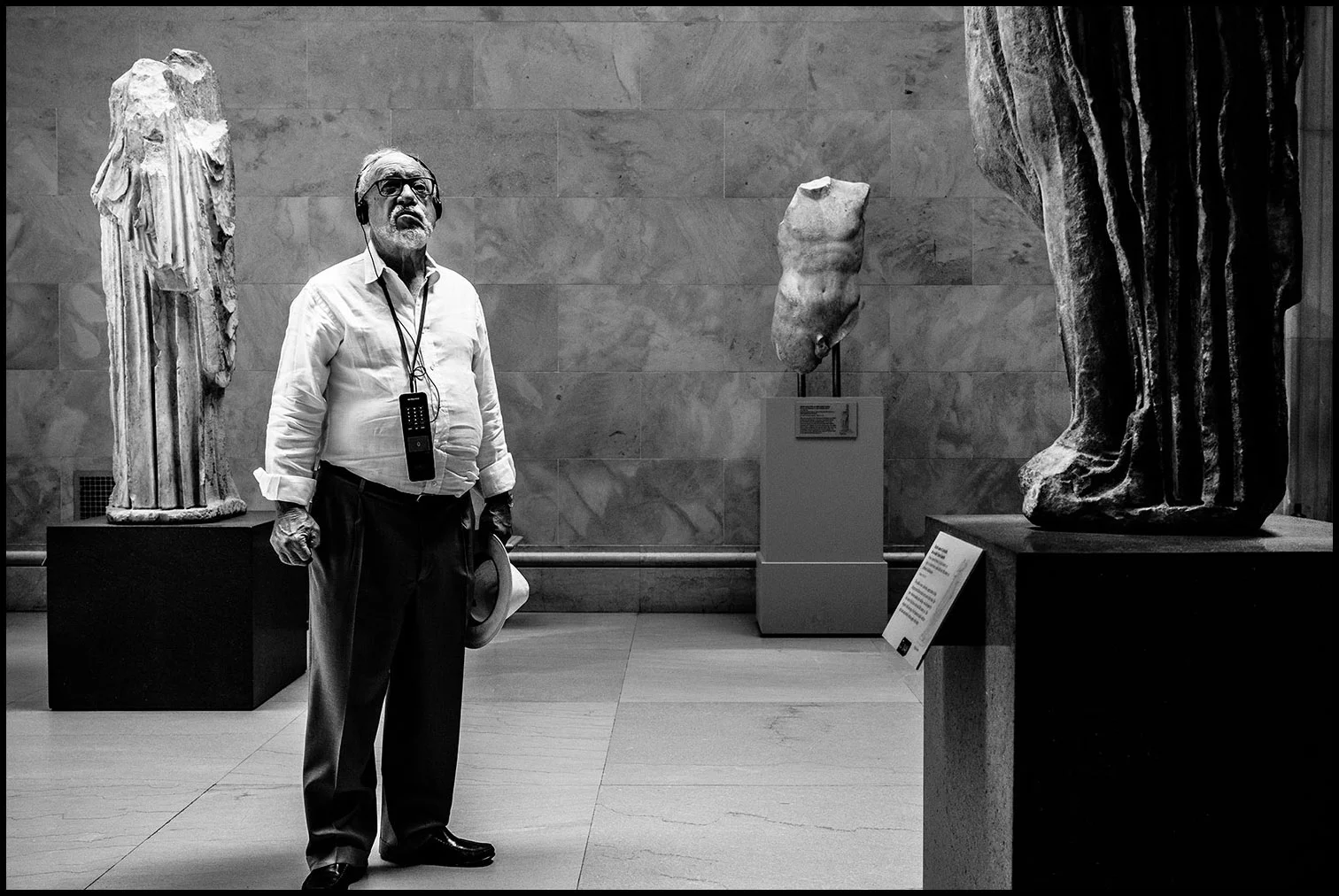 The Art Critic (New York, NY) 2017 // A patron at the Metropolitan Museum of Art gazes at Greco-Roman statues while listening to the audio tour.