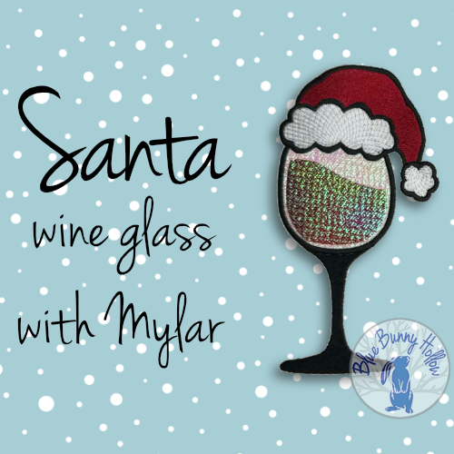 Santa wine glass embroidery design with Mylar shine and Santa hat – Blue Bunny Hollow.