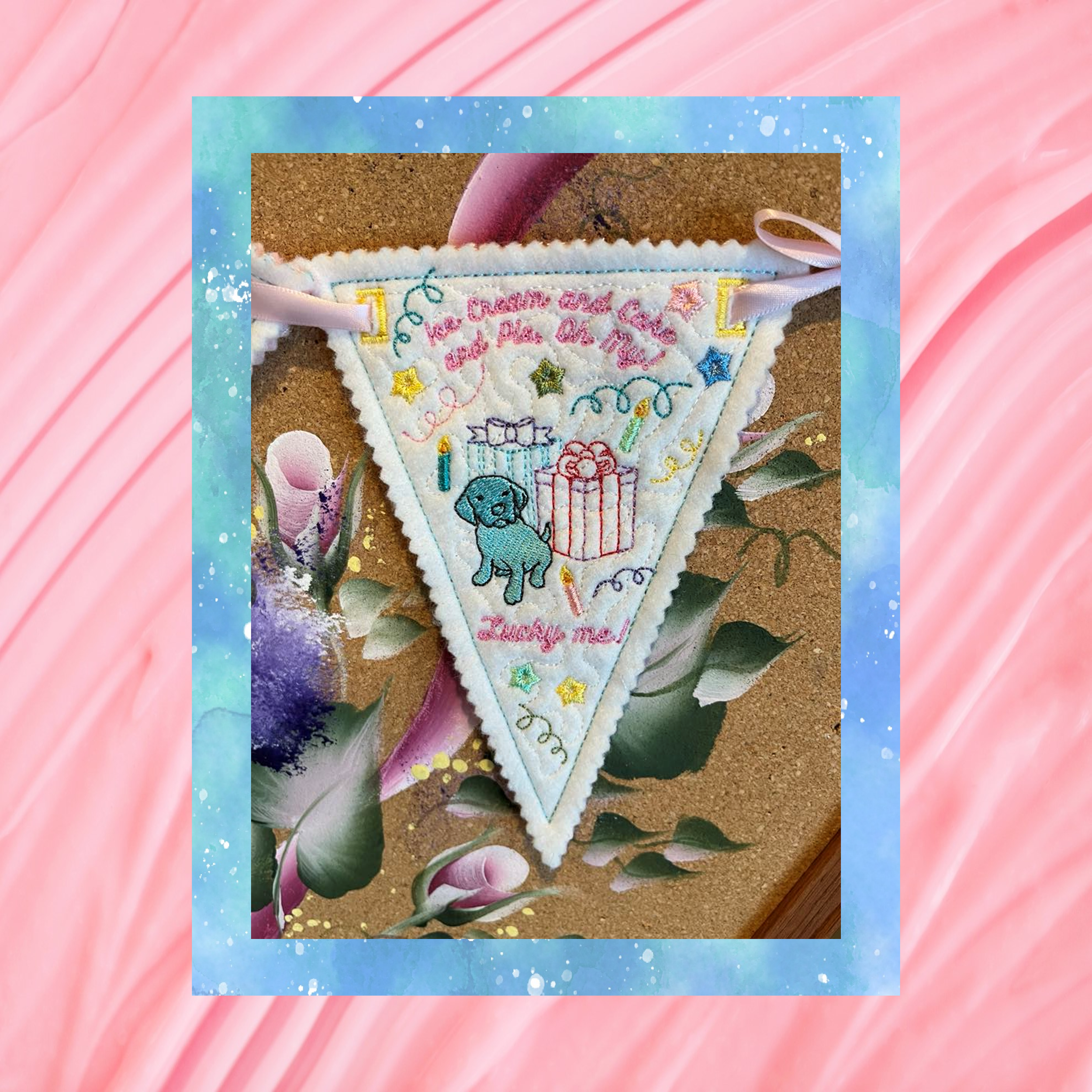 Reusable Happy Birthday bunting, pennant three of three, machine embroidery design stitched in the hoop on felt, featuring a dog, gifts, pastel stitching and pinked edges.