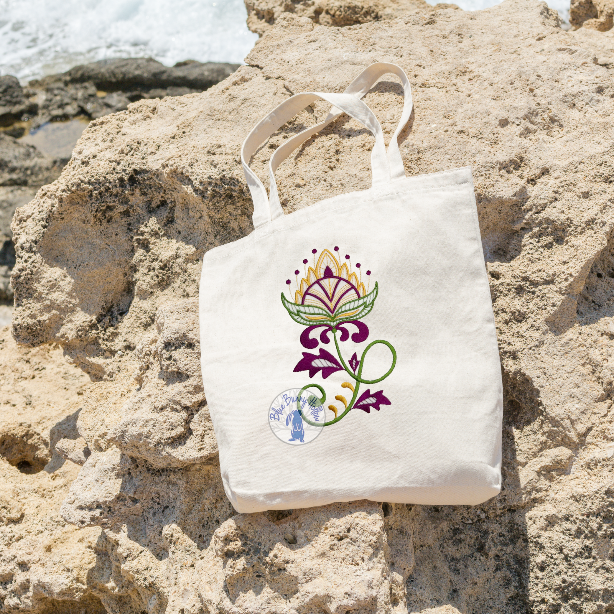 Exquisite Wildflower embroidery design stitched in purple and orange thread.