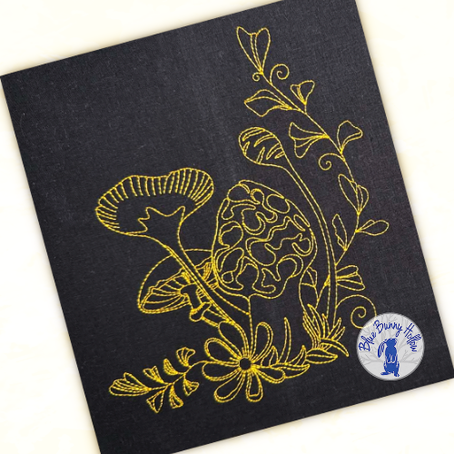 Close-up of Charming Shroom showing delicate machine embroidery line work and fine detailing.