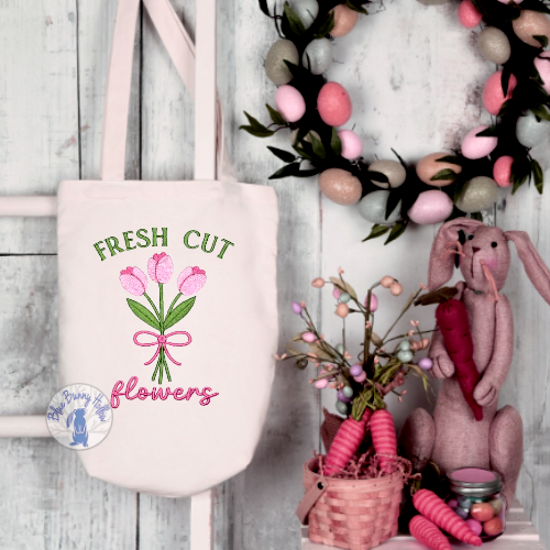 Fresh Cut Flowers embroidery design with tulips and ribbon on tote bag.
