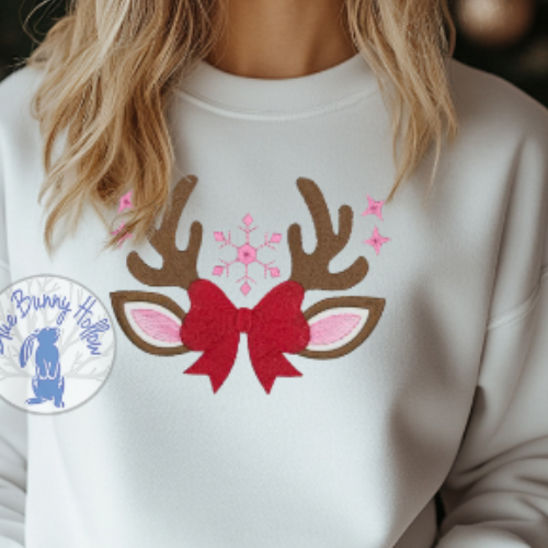 Cute holiday embroidery design featuring reindeer ears and festive bow.