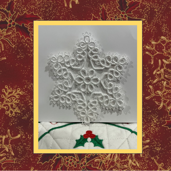 A delicate tatted free-standing lace star snowflake Christmas tree ornament, stitched in white thread.
