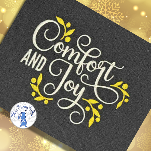Christmas wording machine embroidery “Comfort and Joy” cream lettering.