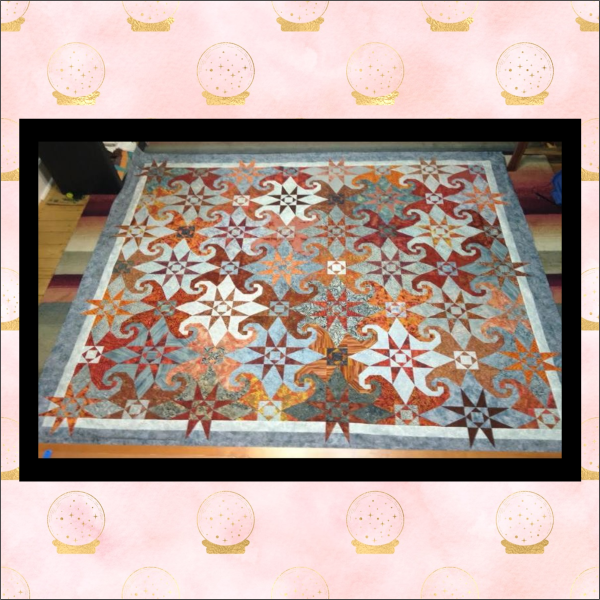 Storm at Sea quilt with Snail Trail centers in blue and rust colored fabrics, stitched in-the-hoop with precise geometric alignment