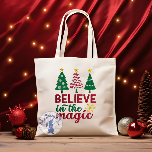 Believe in the Magic embroidery design with Christmas trees and gold snowflake.