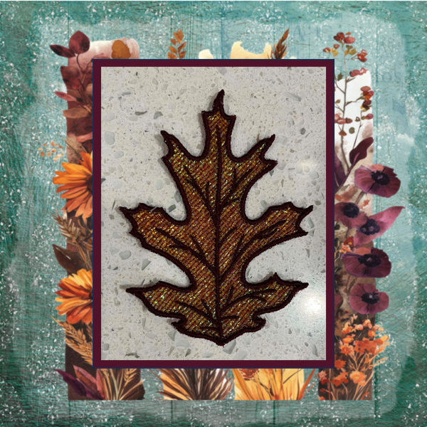 Lace oak leaf machine embroidery design with shimmering Mylar applique and lace background, stitched in rich autumn burgundy and gold.