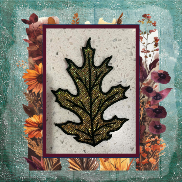 Lace oak leaf machine embroidery design with shimmering Mylar applique and lace background, stitched in rich autumn green and gold.