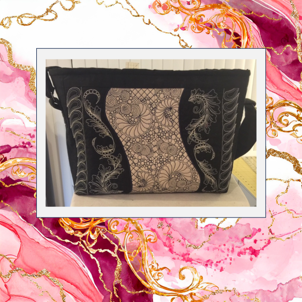 Black and cream machine embroidered purse featuring intricate feather redwork panels with quilted in-the-hoop construction and shoulder strap