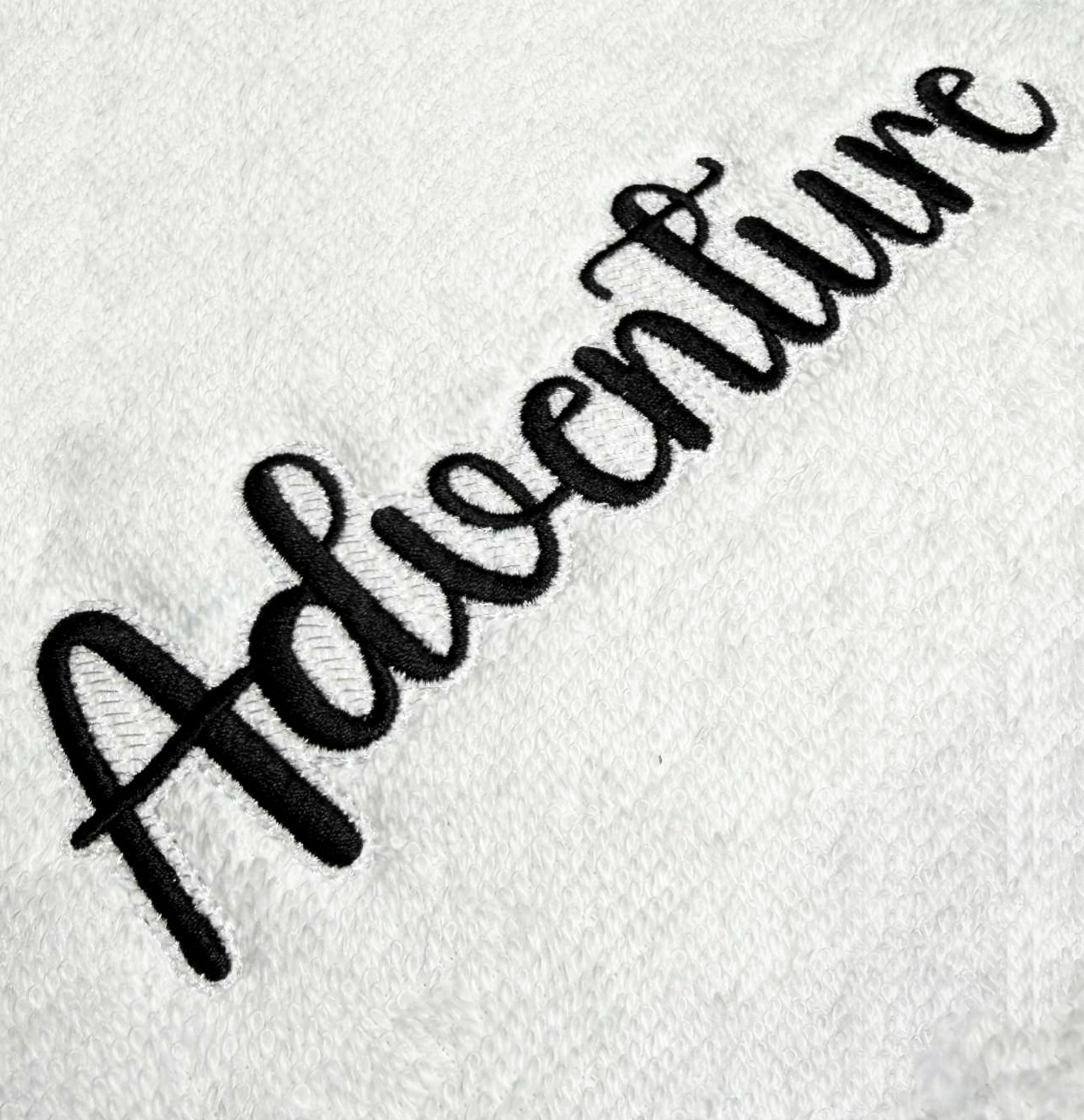 Adventure font with knockdown for custom embroidery digitizing.