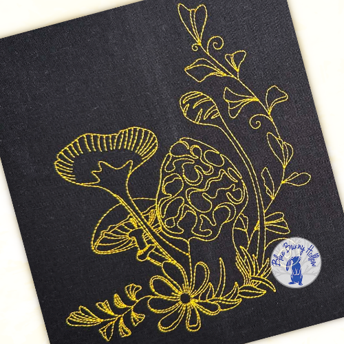 Woodland mushroom line art embroidery stitched with 60-weight thread for detailed definition.