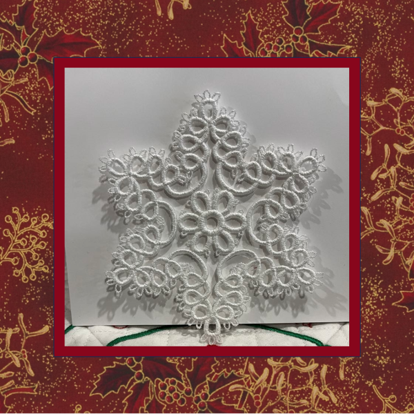 A delicate tatted free-standing lace star snowflake ornament, stitched in white thread for a very elegant Christmas or winter decoration.