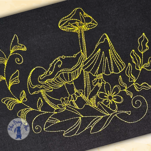 Detailed Pixie Stool mushroom embroidery stitched with fine 60-weight thread.